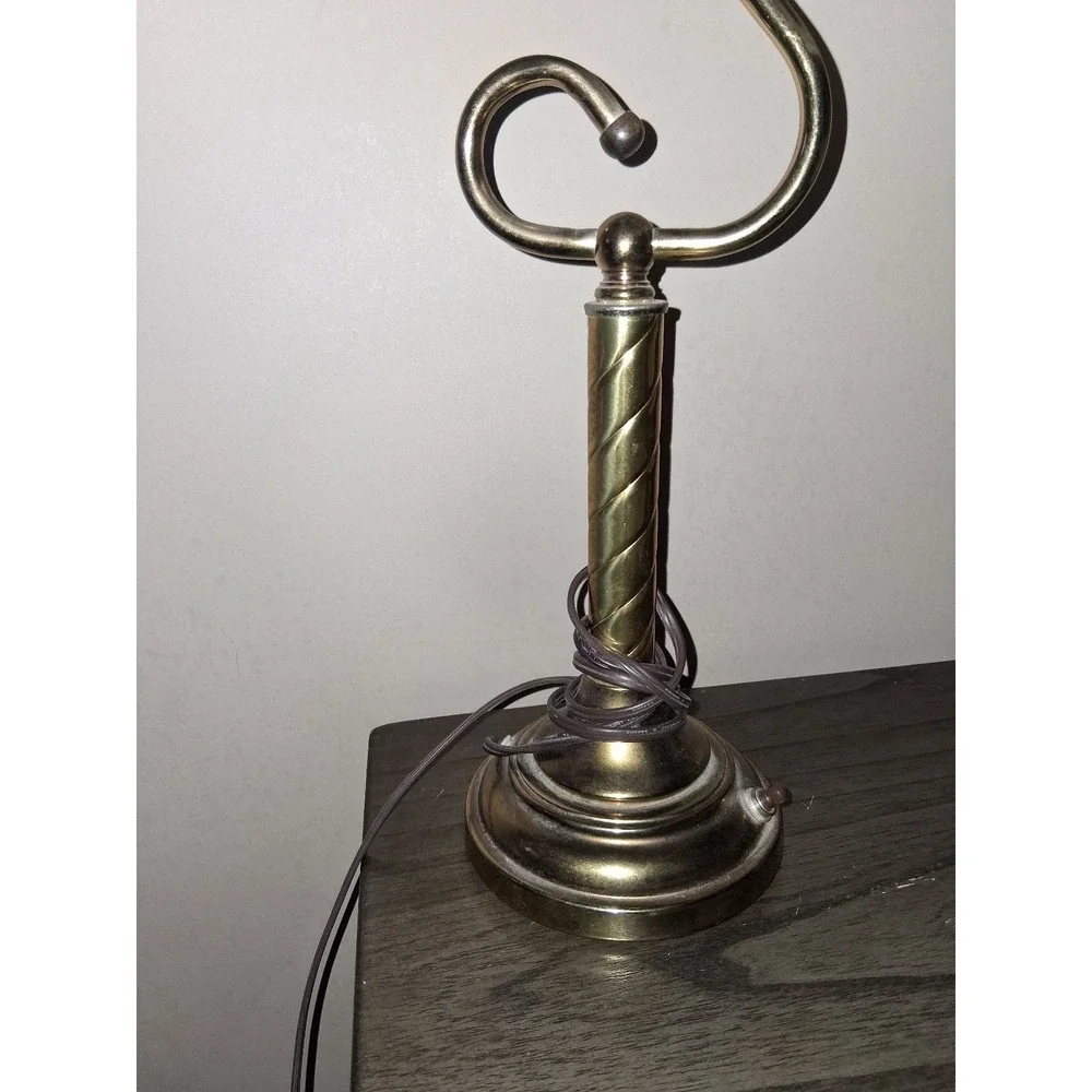 Vintage brass tone desk lamp with elegant scroll arm and classic piano light